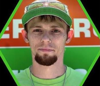 Male SERVPRO employee with a green shirt.