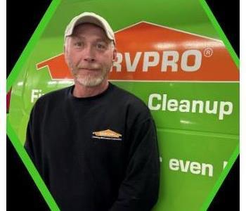 Male SERVPRO employee in black shirt and white ballcap.