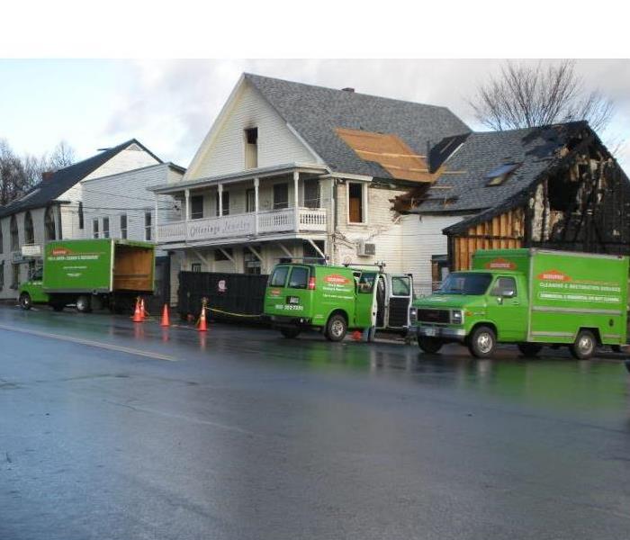SERVPRO trucks parked outside of a commercial fire job.