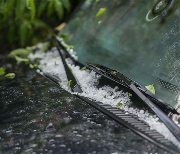 Hail collecting on the windshield of a car