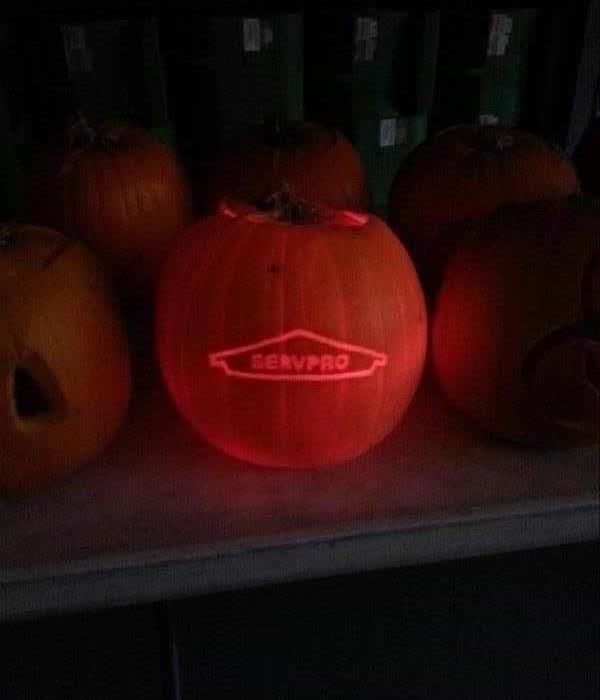 Carved pumpkin with SERVPRO logo.