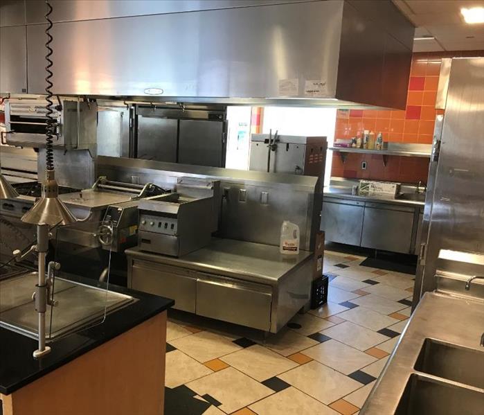 Commercial kitchen including sinks, refrigerators, cooktops and other cooking equipment.