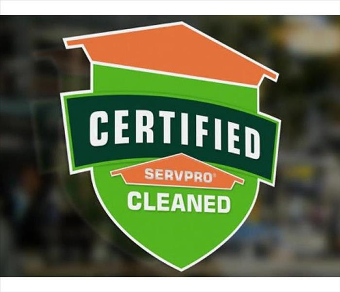 A window decal that says SERVPRO Certified Cleaned