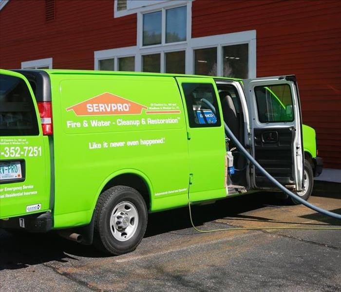 a SERVPRO van outside of a building